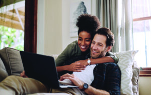 Laptop, Streaming And A Couple Watching A Movie Using An Online Subscription Service For Entertainment Computer, Relax Or Internet With A Man And Woman Bonding Together Over A Video