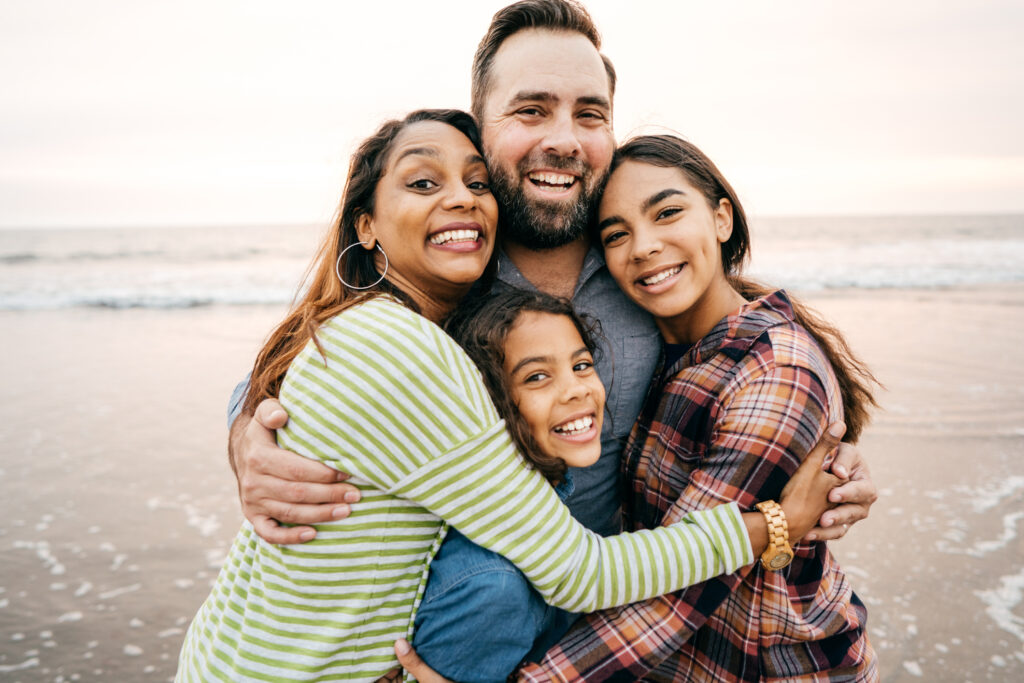 Smiling Parents With Two Children Smiling Parents With Two Children